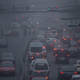 Cars at a smog-filled intersection in Beijing in December 2015. Image: Mark Schiefelbein/AP